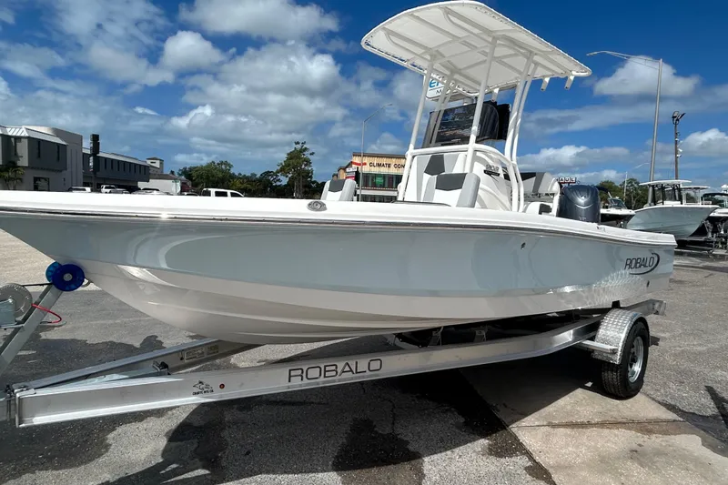 Slide: The Image of 2026 Robalo 206 Cayman boat on trailer under blue sky. - 11