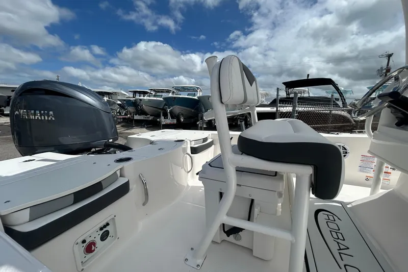 Slide: The Image of 2026 Robalo 206 Cayman boat interior with Yamaha engine, showcasing seating and controls. - 13