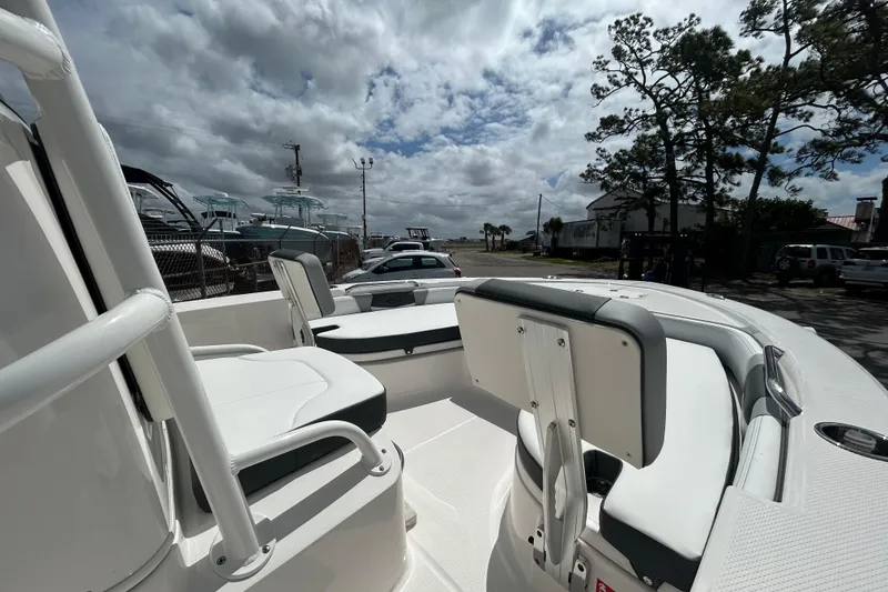 Slide: The Image of 2026 Robalo 206 Cayman boat interior with seating, under a cloudy sky. - 15