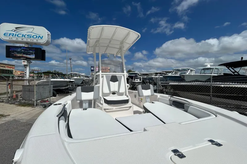 Slide: The Image of 2026 Robalo 206 Cayman boat at Erickson Marine dealership under blue sky. - 16