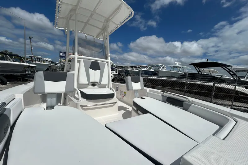 Slide: The Image of 2026 Robalo 206 Cayman boat interior with seating, under a clear blue sky. - 17