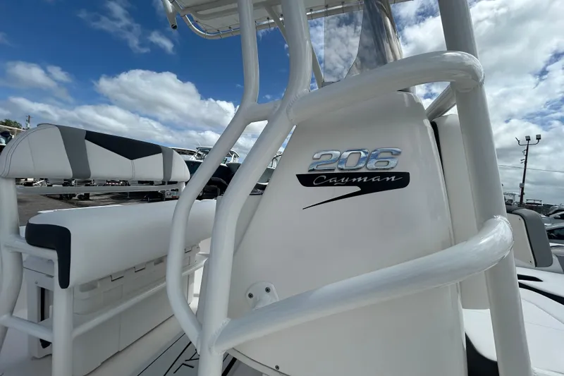 Slide: The Image of 2026 Robalo 206 Cayman boat interior with logo, under a partly cloudy sky. - 20