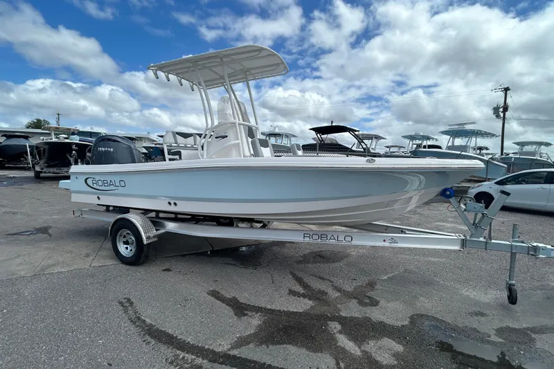 Slide: The Image of 2026 Robalo 206 Cayman boat on trailer under cloudy sky. - 3