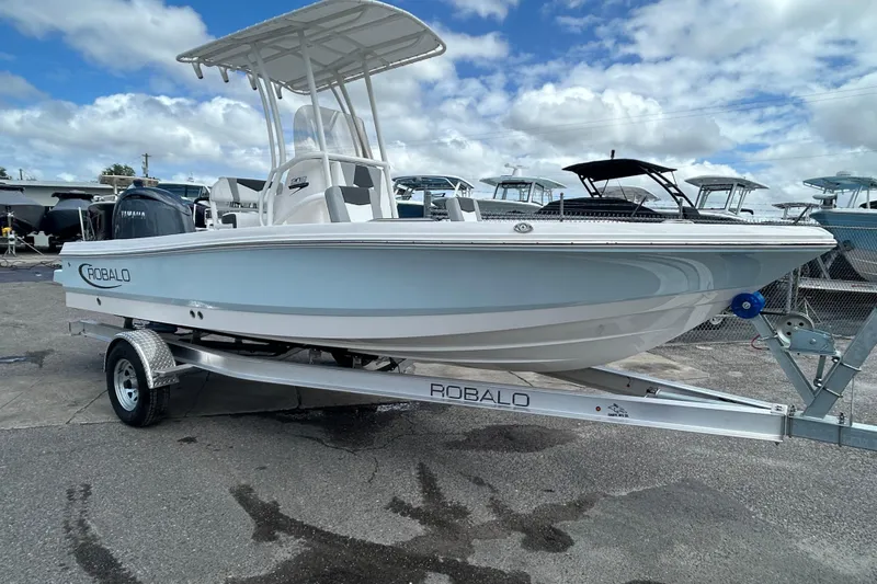 Slide: The Image of 2026 Robalo 206 Cayman boat on trailer under cloudy sky. - 4