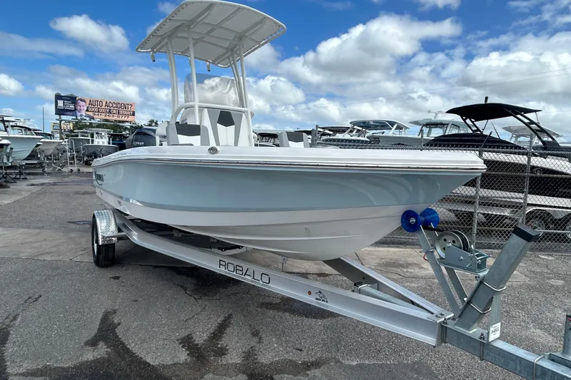 Slide: The Image of 2026 Robalo 206 Cayman boat on trailer under blue sky. - 5