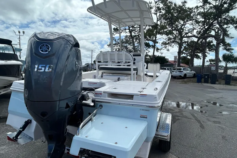 Slide: The Image of 2026 Robalo 206 Cayman boat with Yamaha 150 engine, parked outdoors. - 7