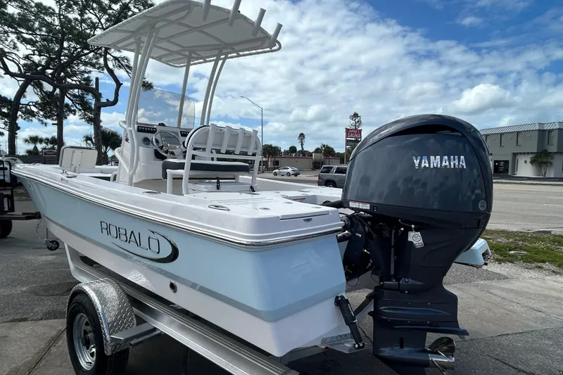 Slide: The Image of 2026 Robalo 206 Cayman boat with Yamaha engine on trailer, parked outdoors. - 9