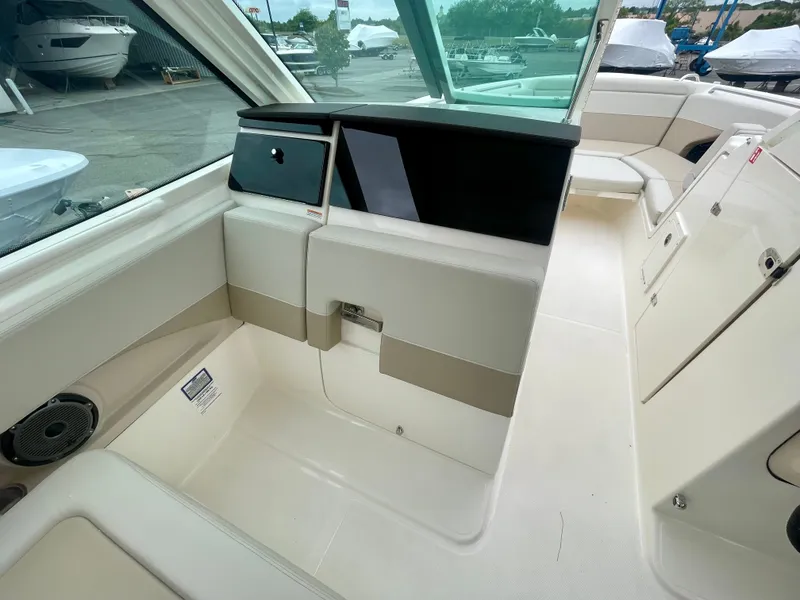 Slide: The Image of The image shows the cockpit of a 2027 Boston Whaler 280 Vantage with beige seating and a helm station. - 24