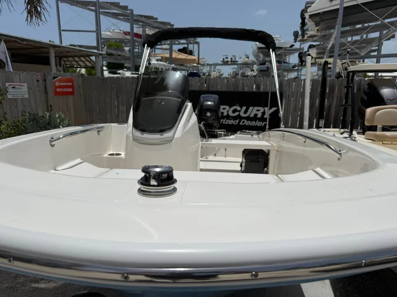 Slide: The Image of A 2026 Boston Whaler 130 Super Sport in a marina area. It features a clean, modern design. - 6