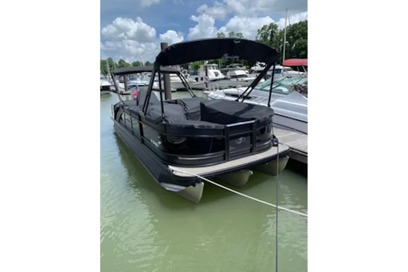Slide: The Image of 2021 Barletta L25UE pontoon boat docked on a sunny day. - 3