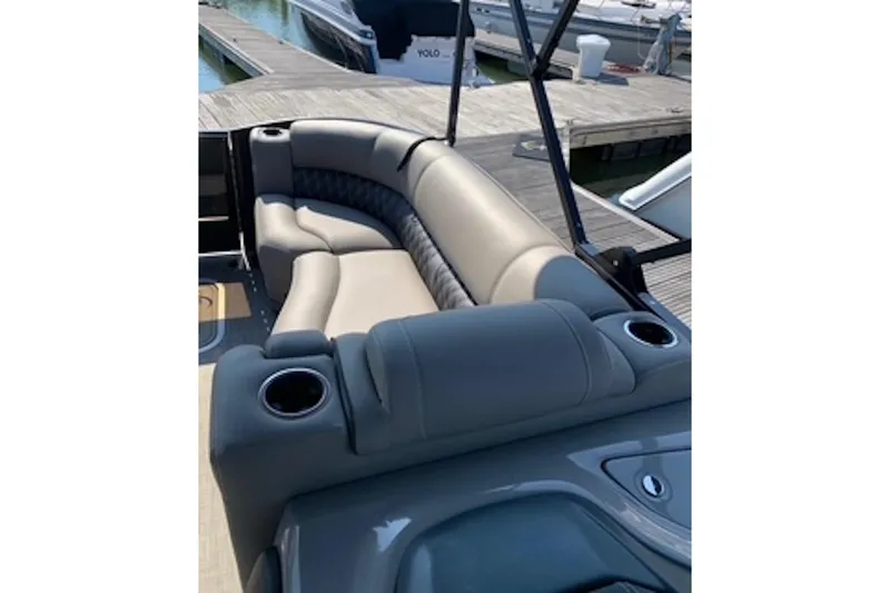 Slide: The Image of Luxurious seating on a 2021 Barletta L25UE pontoon boat at a dock. - 9