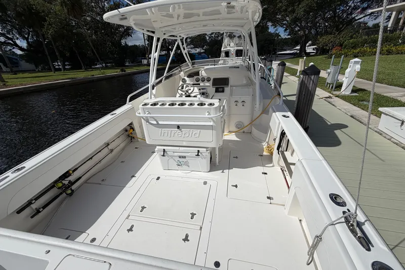 Slide: The Image of 2008 Intrepid 350 Center Console boat docked, showcasing spacious deck and fishing equipment. - 10