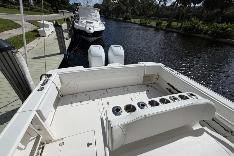 Slide: The Image of 2008 Intrepid 350 Center Console boat docked, featuring spacious seating and dual outboard engines. - 12