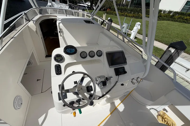 Slide: The Image of 2008 Intrepid 350 Center Console boat cockpit with steering wheel and navigation instruments. - 17