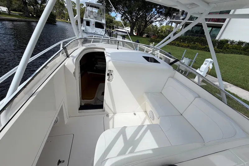 Slide: The Image of 2008 Intrepid 350 Center Console boat interior with white seating and open cabin door. - 19