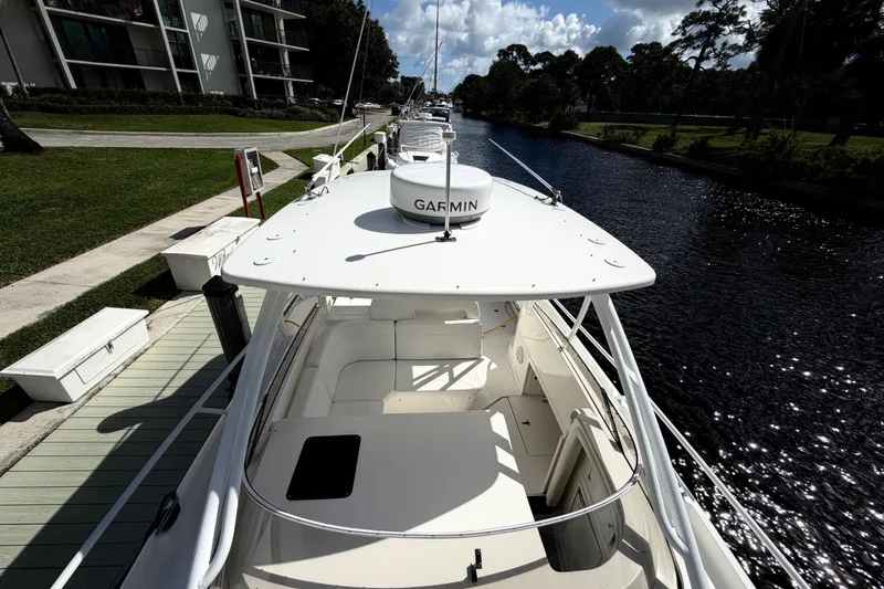 Slide: The Image of 2008 Intrepid 350 Center Console boat docked by a scenic canal. - 21