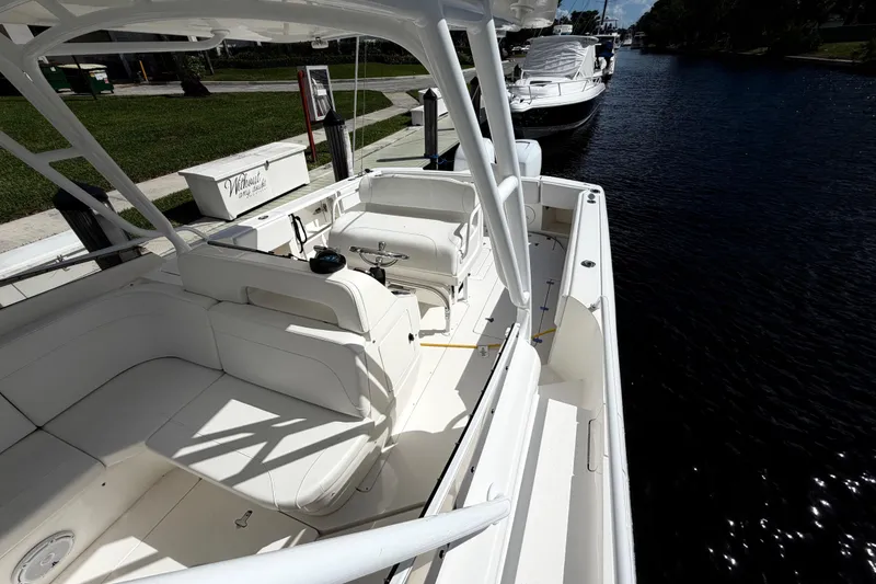 Slide: The Image of 2008 Intrepid 350 Center Console boat docked on a sunny day, showcasing spacious seating. - 22