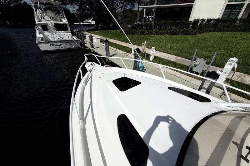 Slide: The Image of 2008 Intrepid 350 Center Console docked near another boat, sunny day. - 27
