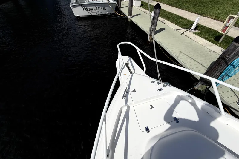 Slide: The Image of 2008 Intrepid 350 Center Console boat docked at marina, shadow on deck. - 28