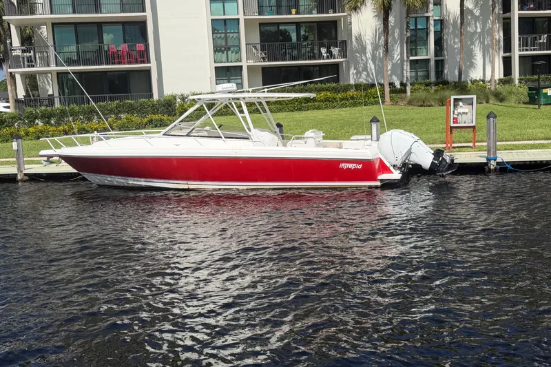 Slide: The Image of 2008 Intrepid 350 Center Console boat docked by waterfront apartments. - 3