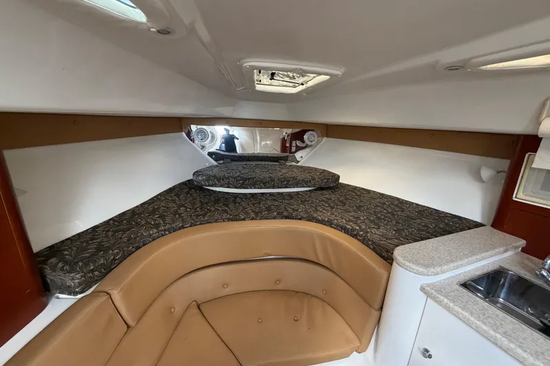Slide: The Image of 2008 Intrepid 350 Center Console cabin interior with bed and kitchenette. - 30