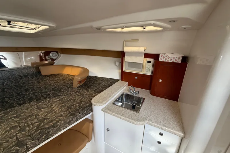 Slide: The Image of 2008 Intrepid 350 Center Console cabin with kitchenette and cozy seating area. - 33