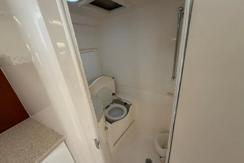Slide: The Image of 2008 Intrepid 350 Center Console boat bathroom interior with toilet and countertop. - 37