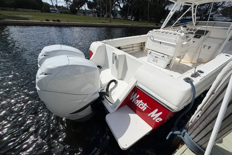 Slide: The Image of 2008 Intrepid 350 Center Console boat with dual engines docked by the water. - 7
