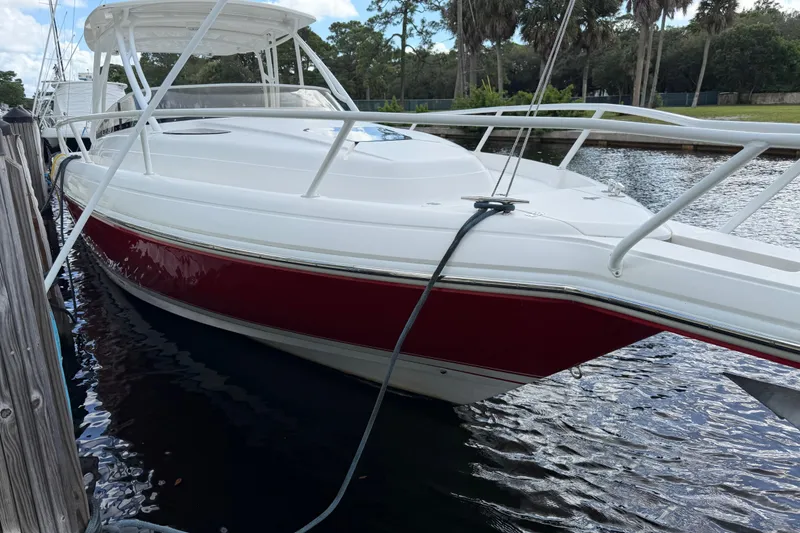 Slide: The Image of 2008 Intrepid 350 Center Console boat docked, featuring a sleek white and red design. - 9