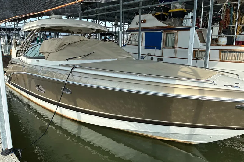 The Image of 2014 Formula 350 Crossover Bowrider docked in a marina, covered and secured. - 0