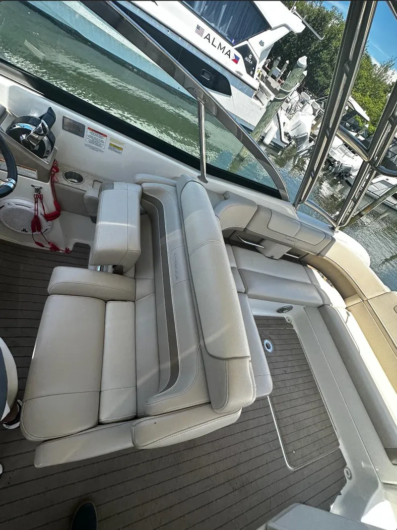 Slide: The Image of 2014 Formula 350 Crossover Bowrider with spacious seating and sleek design at a marina. - 12