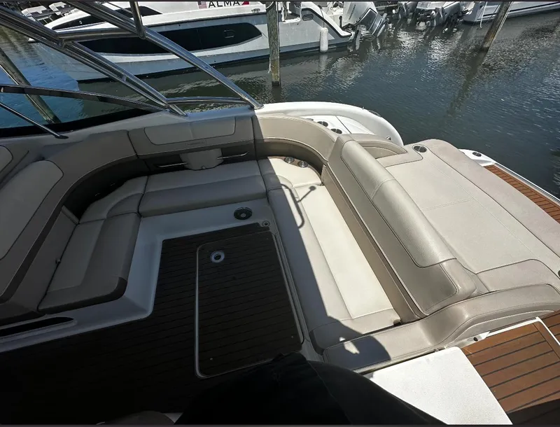 Slide: The Image of 2014 Formula 350 Crossover Bowrider interior with beige seating and wooden flooring. - 13