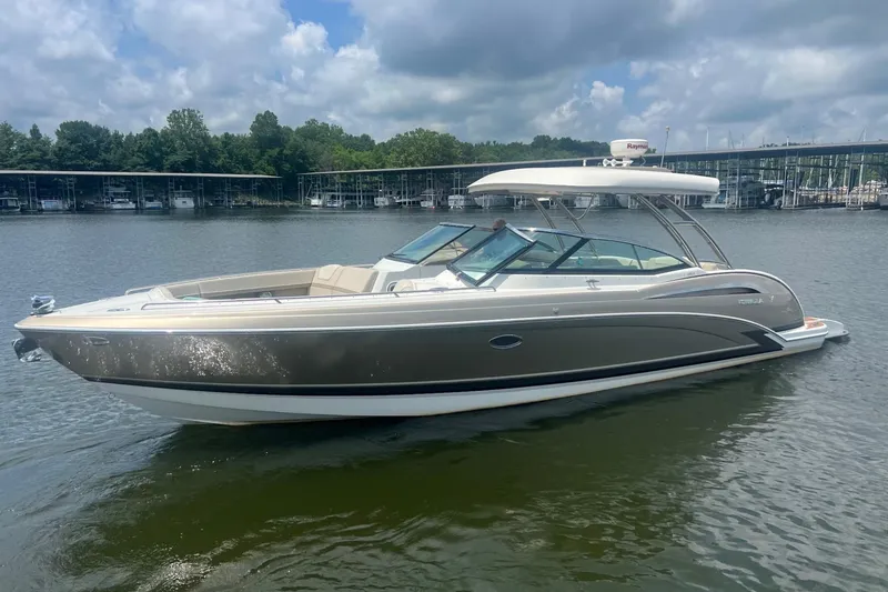 Slide: The Image of 2014 Formula 350 Crossover Bowrider on calm water under a cloudy sky. - 2