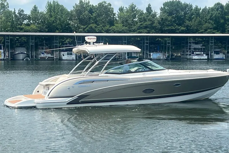 Slide: The Image of 2014 Formula 350 Crossover Bowrider on a calm lake near a marina. - 4