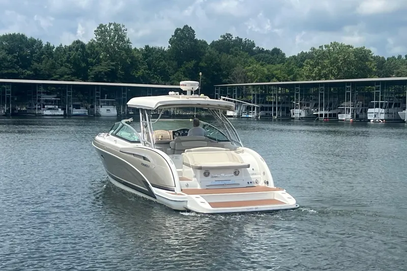 Slide: The Image of 2014 Formula 350 Crossover Bowrider on a serene lake near a marina. - 6