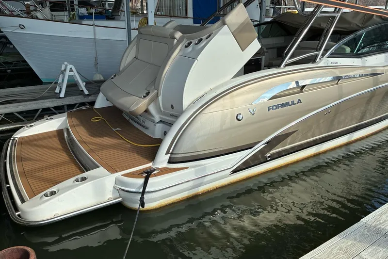 Slide: The Image of 2014 Formula 350 Crossover Bowrider docked, featuring sleek design and spacious deck. - 8