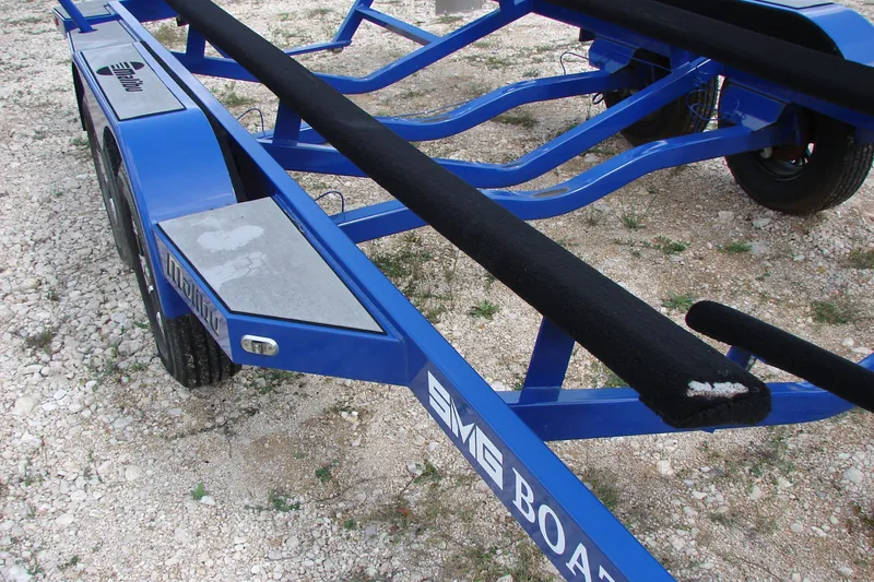 Slide: The Image of Blue trailer for 2017 Malibu Wakesetter 24 MXZ on gravel surface. - 17