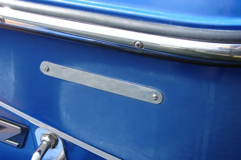 Slide: The Image of 2017 Malibu Wakesetter 24 MXZ boat, blue exterior with metal trim detail. - 19