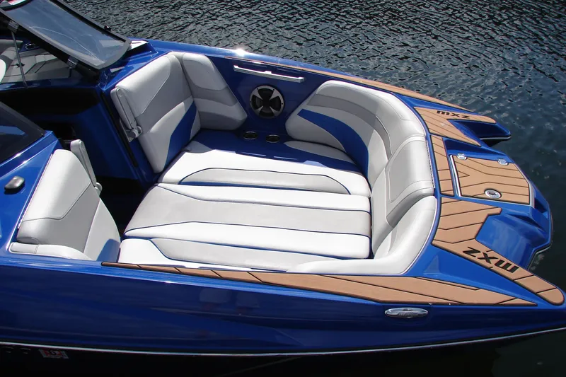 Slide: The Image of 2017 Malibu Wakesetter 24 MXZ boat interior with blue and white seating. - 23