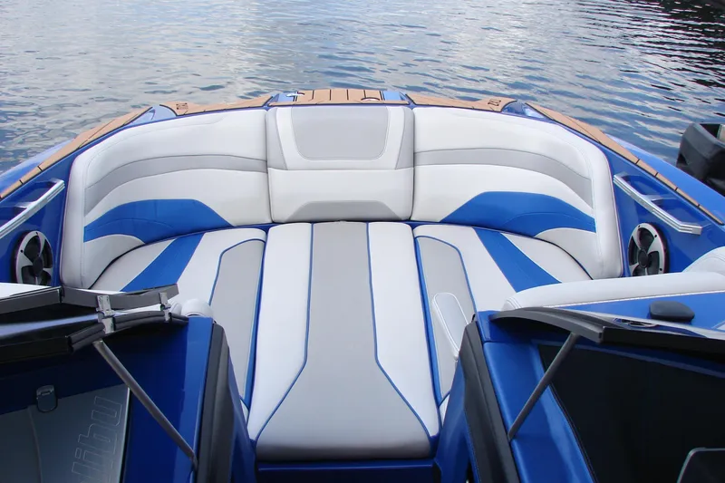 Slide: The Image of 2017 Malibu Wakesetter 24 MXZ boat interior with blue and white seating. - 25