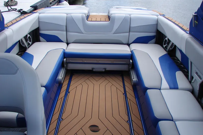 Slide: The Image of 2017 Malibu Wakesetter 24 MXZ interior with blue and white seating, teak flooring. - 36