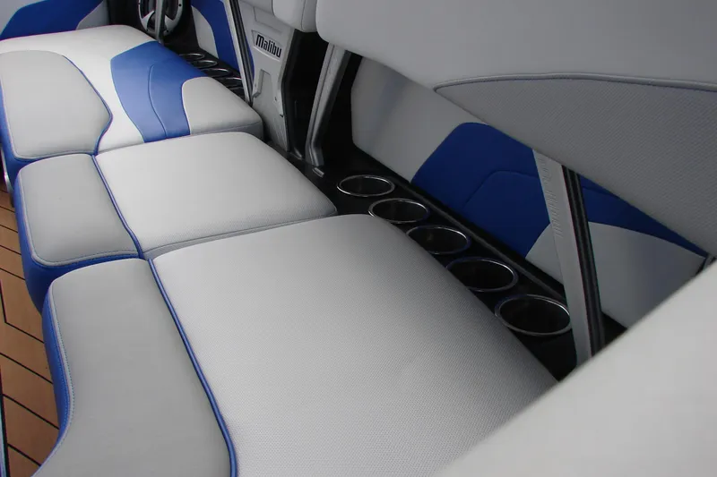 Slide: The Image of 2017 Malibu Wakesetter 24 MXZ interior with blue and gray seating and cup holders. - 38