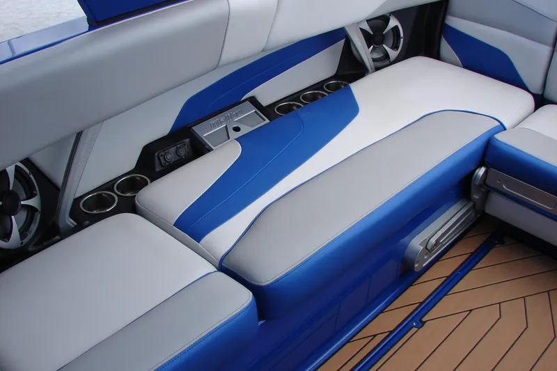 Slide: The Image of 2017 Malibu Wakesetter 24 MXZ interior with blue and white seating, cup holders, and speakers. - 39