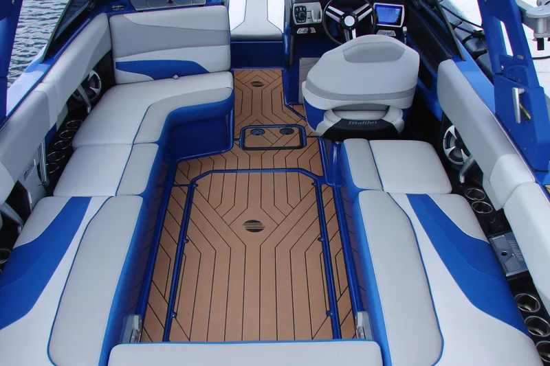 Slide: The Image of 2017 Malibu Wakesetter 24 MXZ interior with blue and white seating, teak flooring. - 46