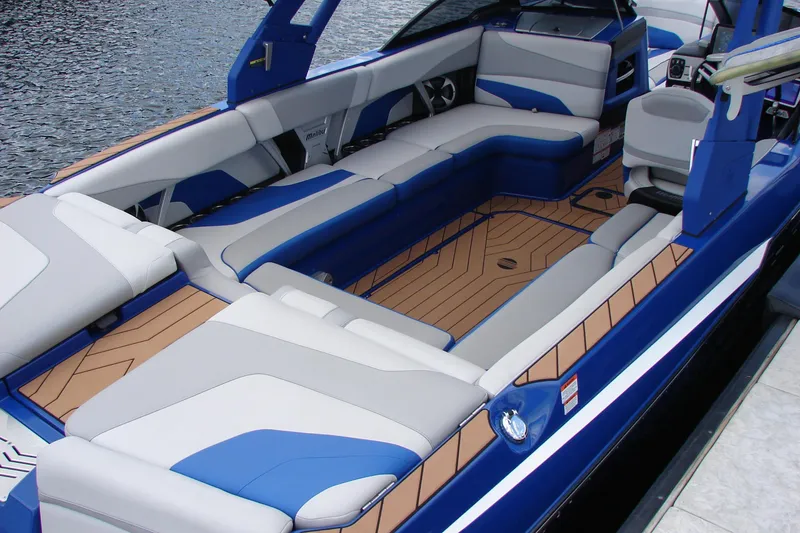 Slide: The Image of 2017 Malibu Wakesetter 24 MXZ interior with blue and gray seating on the water. - 47