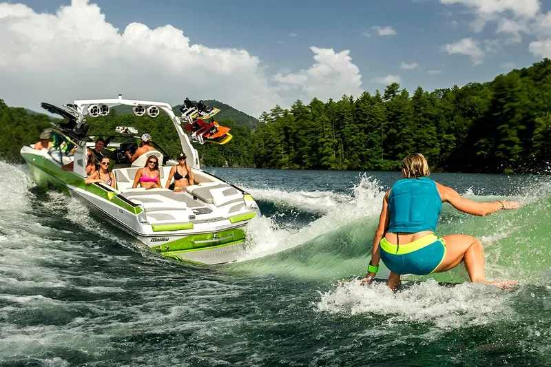 Slide: The Image of Manufacturer Provided Image: 2017 Malibu Wakesetter 24 MXZ towing a wakeboarder on a scenic lake. - 52