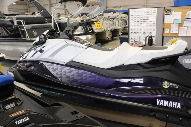 Slide: The Image of 2026 Yamaha WaveRunner VX Cruiser HO in showroom, featuring sleek design and white seating. - 2