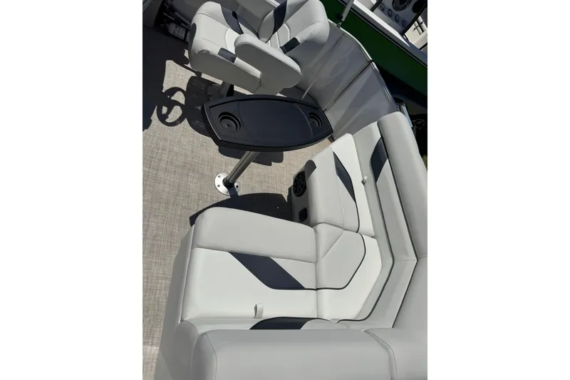 Slide: The Image of 2022 SunCatcher Select 16C boat interior with gray seating and a central table. - 10