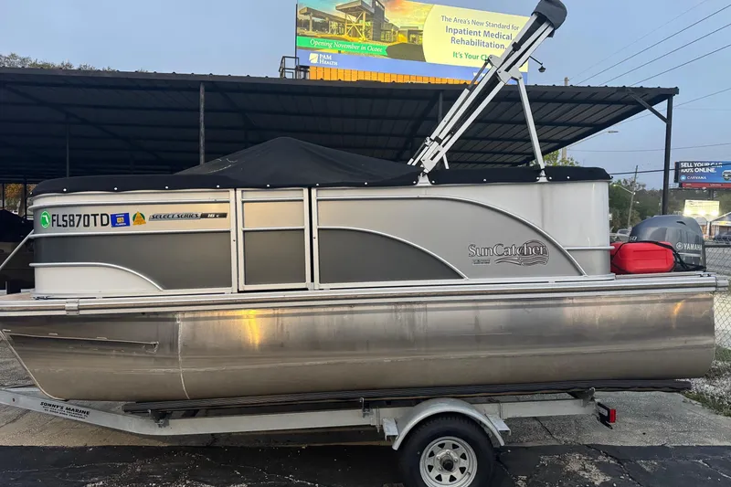 Slide: The Image of 2022 SunCatcher Select 16C pontoon boat on trailer, parked outdoors. - 9