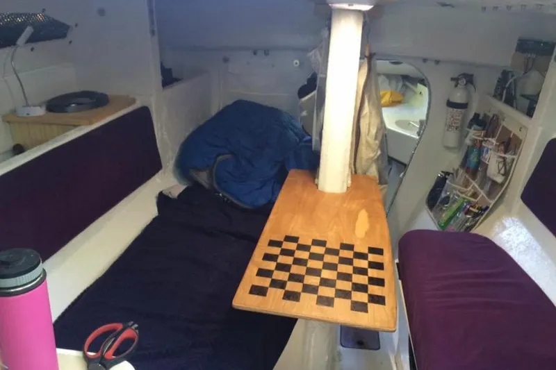 Slide: The Image of Interior of a 1991 Corsair F 27 sailboat with a wooden chessboard table. - 7